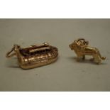 Two gold charms, a hovercraft and a lion, stamped 375, 12.7g.