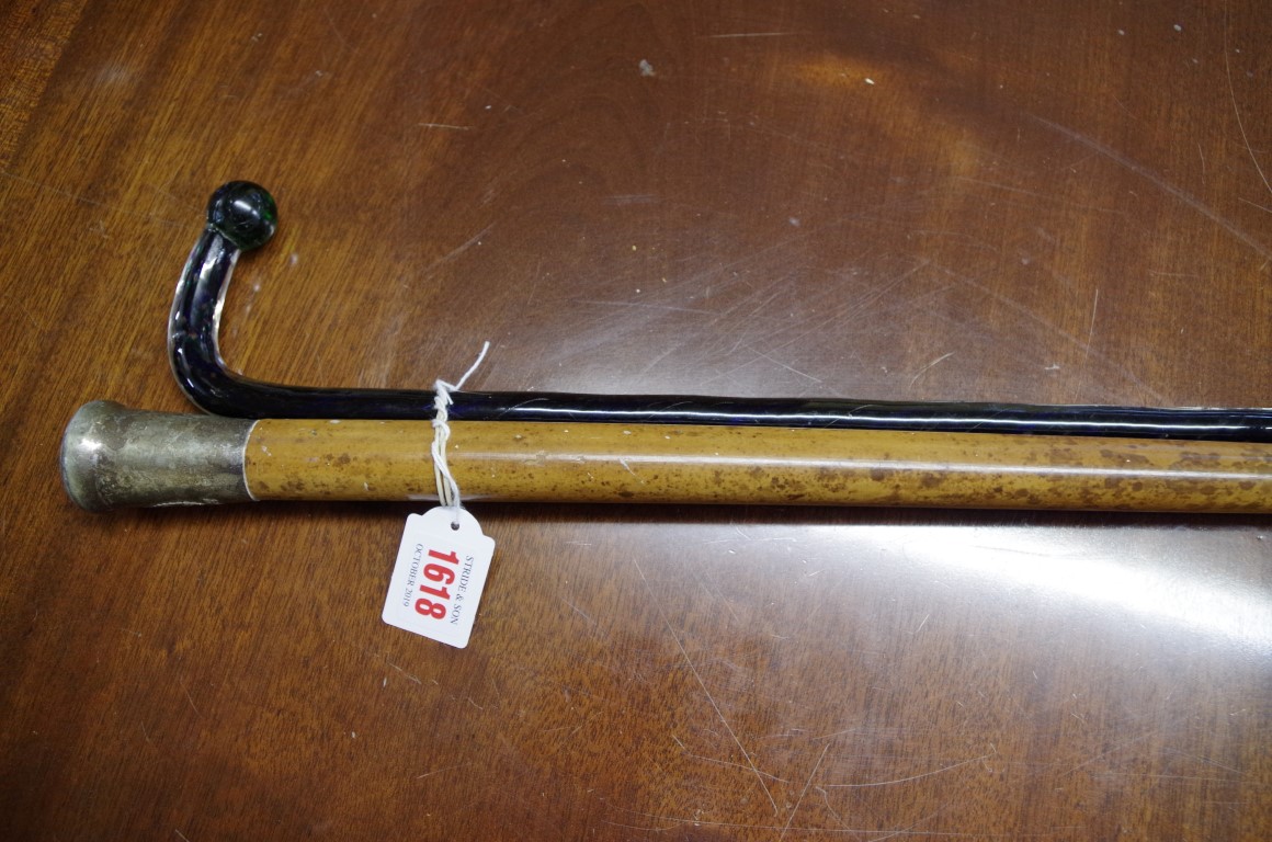 A malacca cane; together with a novelty glass walking stick.