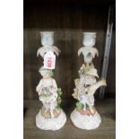 A pair of Sitzendorf porcelain figural candlesticks, emblematic of the seasons, 26.5cm high, (s.d.