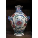 An Iznik style pottery twin handled vase, mark to base, 33.5cm high.