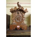 A late 19th century Black Forest carved walnut cuckoo mantel clock, 38.5cm high.