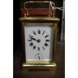 An old brass carriage clock, with bell striking alarm, height including handle 14.5cm, with