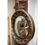 A reproduction gilt framed convex wall mirror, 42cm diameter.