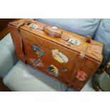 A vintage tan leather suitcase.
