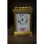 An old gilt brass carriage timepiece, height including handle 14cm.