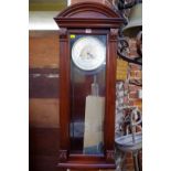 A reproduction mahogany Vienna style wall clock, the dial inscribed 'Howard Miller', with spring