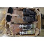 Two pairs of field glasses, one with broad arrow stamp, each in tan leather case.