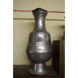 An antique Continental large pewter flagon, 46cm high.