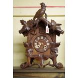 A late 19th century Black Forest carved walnut cuckoo mantel clock, 40.5cm high.