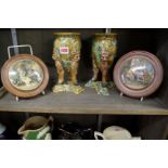 A pair of majolica tripod vases, 20cm high; together with two Victorian pot lids.