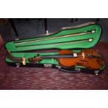 An antique violin, with 14in two piece back, two bows and case.