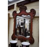 An 18th century style red lacquered and parcel gilt wall mirror, 57.5cm high.