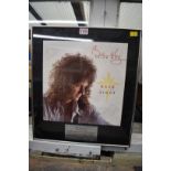An autographed Brian May 'Back to the Light' album cover, in presentation frame.