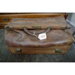 An old tan leather Gladstone bag, with hinged compartment to base.