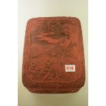 A cinnabar lacquer rectangular box and cover, relief decorated with cranes, 27cm wide.