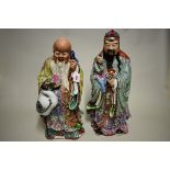 A large and impressive pair of Chinese famille rose Daoist immortals, seal marks to base of each,