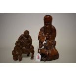 A Chinese carved rootwood figure group, Qing, 26cm high; together with another Chinese carved bamboo