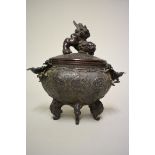 An unusual Chinese bronze twin handled hexagonal censer and cover, with lion dog finial, flower head