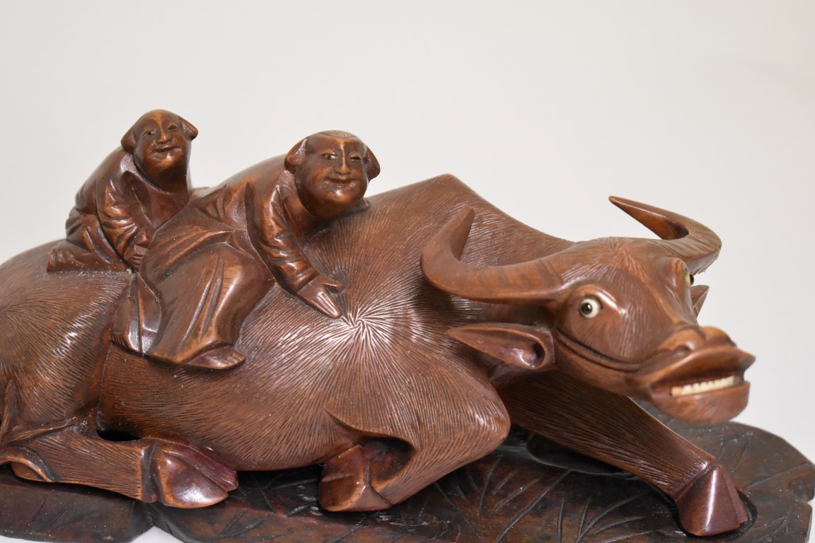 A pair of Chinese carved wood buffalo figure groups, late 19th century, each recumbent animal with - Image 4 of 5