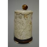 A Japanese ivory tusk vase and cover, Meiji, carved in relief with a figure and geishas in a garden,