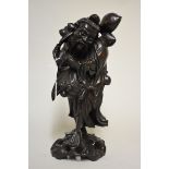 A Chinese carved hardwood figure, 36cm high.