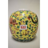 A Chinese famille verte yellow ground jar, painted with two dragons and a flaming pearl amidst