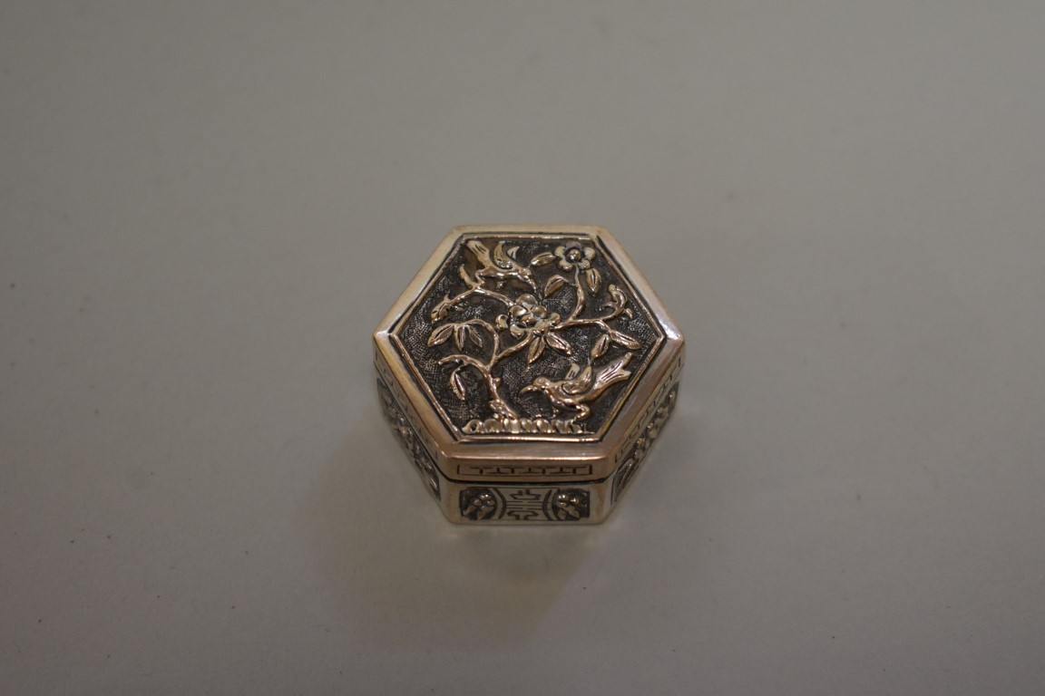 A small Chinese silver hexagonal casket, 3.7cm wide.