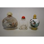 Three Chinese snuff bottles, comprising: an internally painted rock crystal example, height