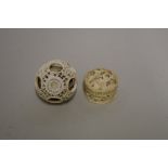 A Chinese carved ivory concentric puzzle ball, 3.6cm diameter; together with another small carved