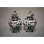 A large pair of Chinese famille verte inverted baluster vases and cover, Qing, painted with birds