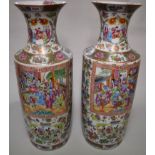 A very large and impressive pair of Chinese Canton famille rose rouleau vases, 19th century, each