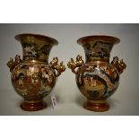 A pair of Japanese Satsuma pottery twin handled vases, seal marks, 22cm high. (2)