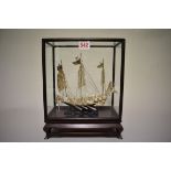 A Chinese silver model of a junk, by Wei Kei, Hong Kong, stamped sterling silver, on wood stand, the
