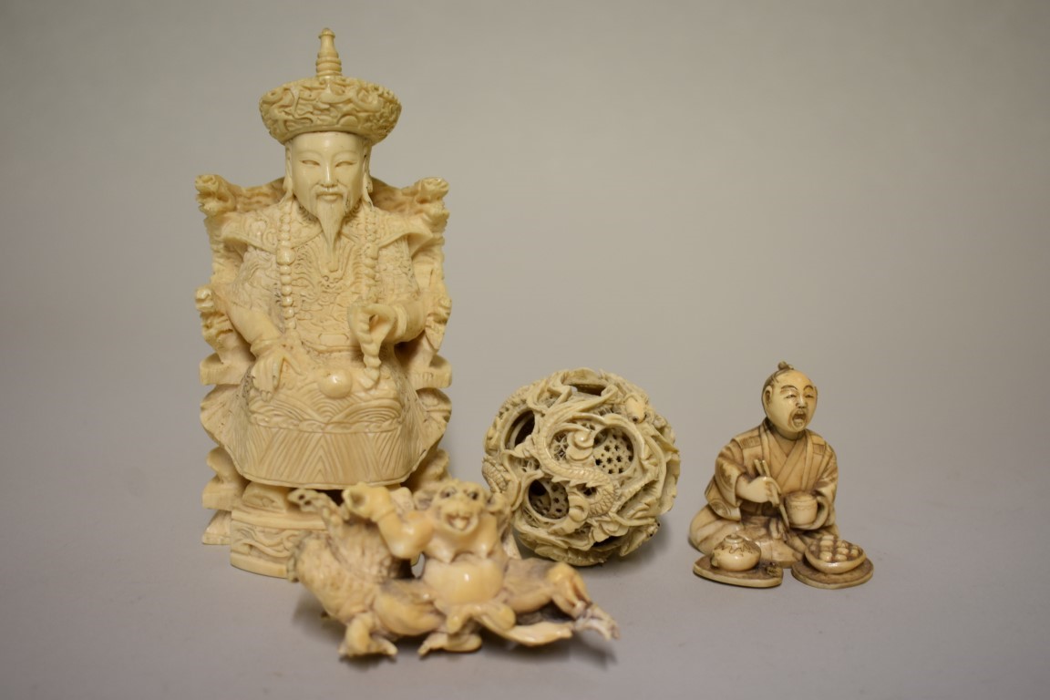 A small group of Chinese and Japanese carved ivory, comprising: a seated figure, seal mark to