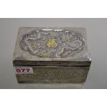 A Chinese silver and parcel gilt rectangular casket, repousse decorated to the hinged lid with