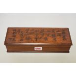 A Chinese hardwood rectangular box and cover, the cover inscribed with lines of script, 28cm wide.