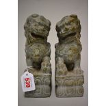 A pair of Chinese green jade or soapstone lion dogs, 21.5cm high. (2)