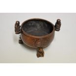 A Chinese bronze twin handled tripod censer, nine character seal mark to base, with figure handles