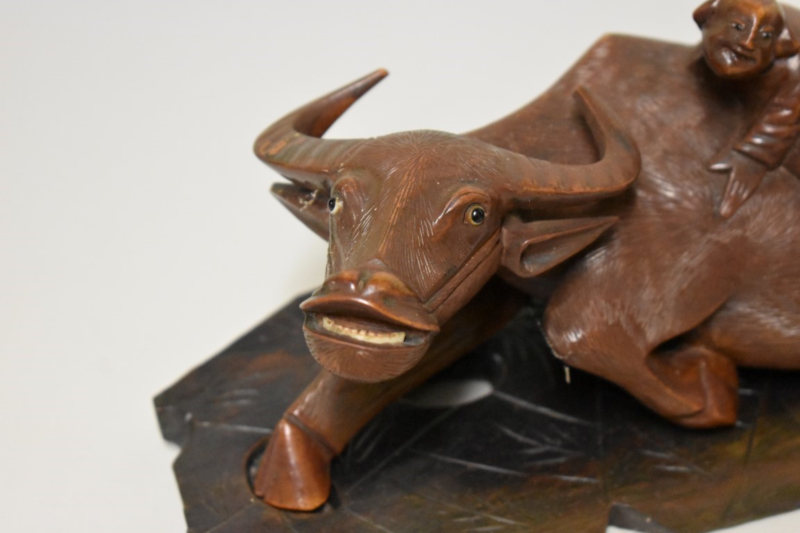 A pair of Chinese carved wood buffalo figure groups, late 19th century, each recumbent animal with - Image 2 of 5