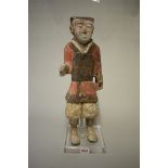 A Chinese terracotta figure of a soldier, Han dynasty, with remains of painted decoration, 46.5cm