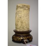 A good Chinese ivory tusk vase, finely carved with a continuous band of figures, on gilt decorated