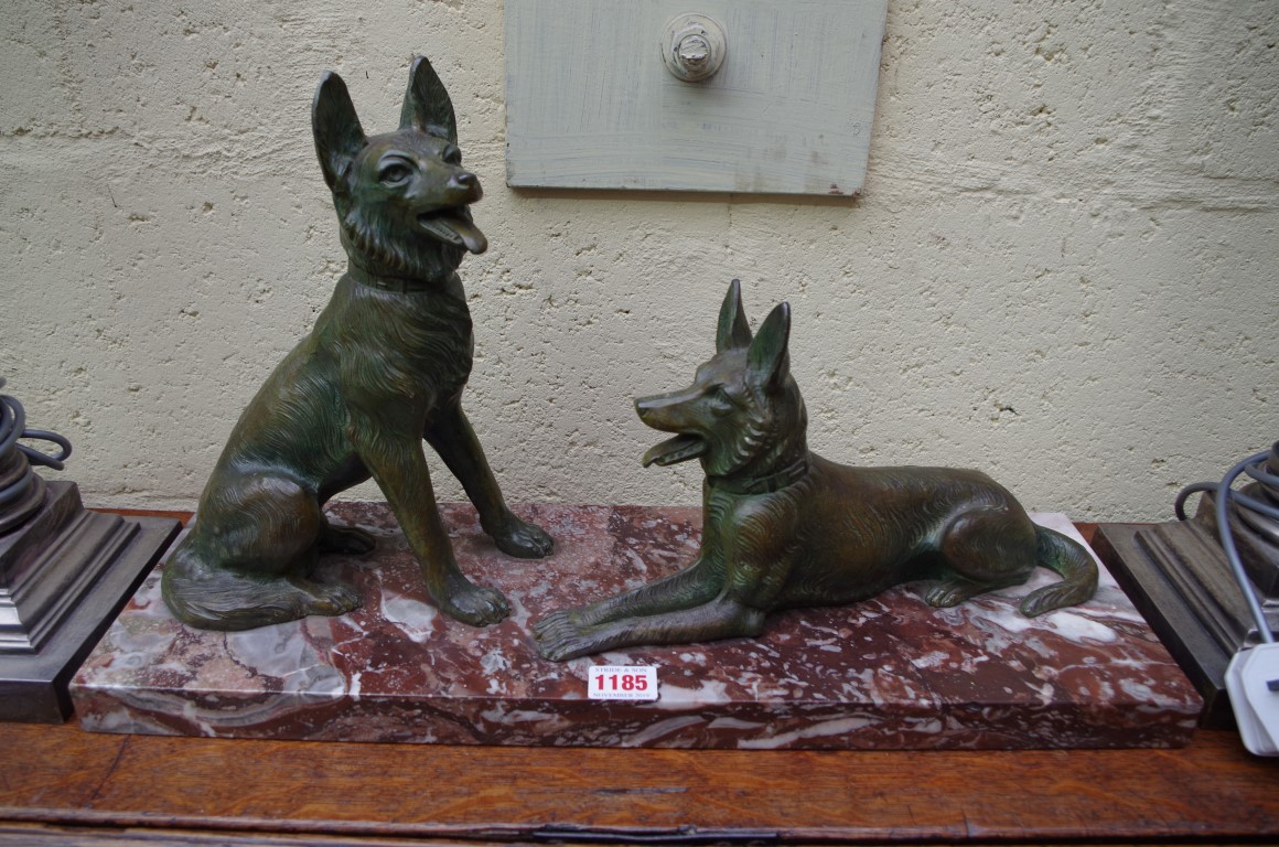 A verdigris metal and marble figure group of two alsatians, 52cm wide.