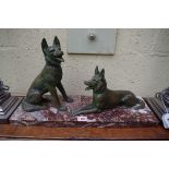 A verdigris metal and marble figure group of two alsatians, 52cm wide.