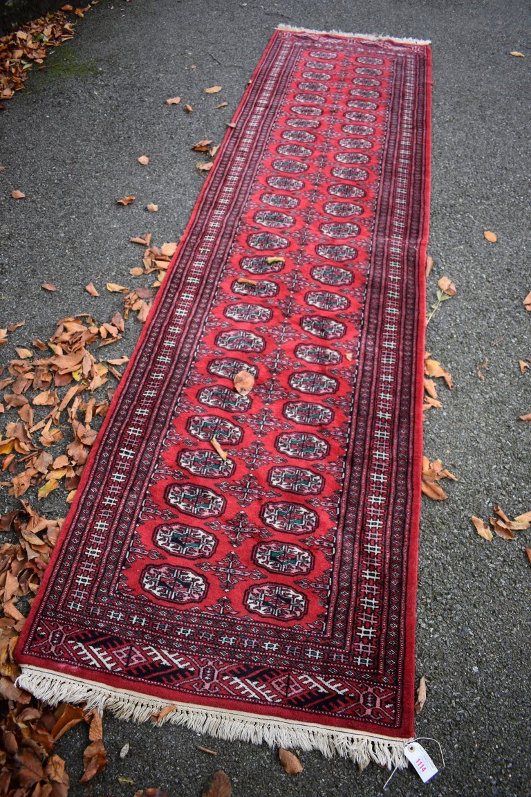 An Afghan runner, having allover geometric design, 318 x 80cm.