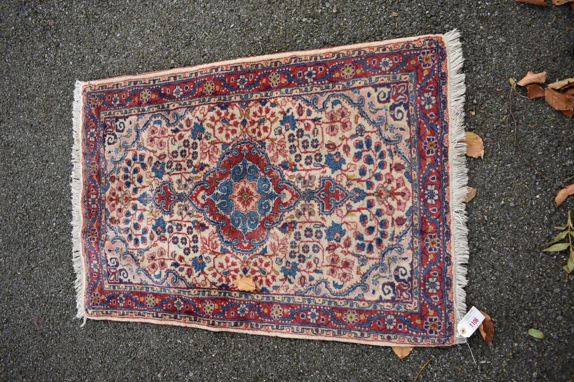 A small Persian rug, with allover floral design, 102 x 70cm.