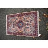A small Persian rug, with allover floral design, 102 x 70cm.