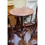 An old mahogany circular tripod table, 41.5cm diameter; together with another carved mahogany tripod