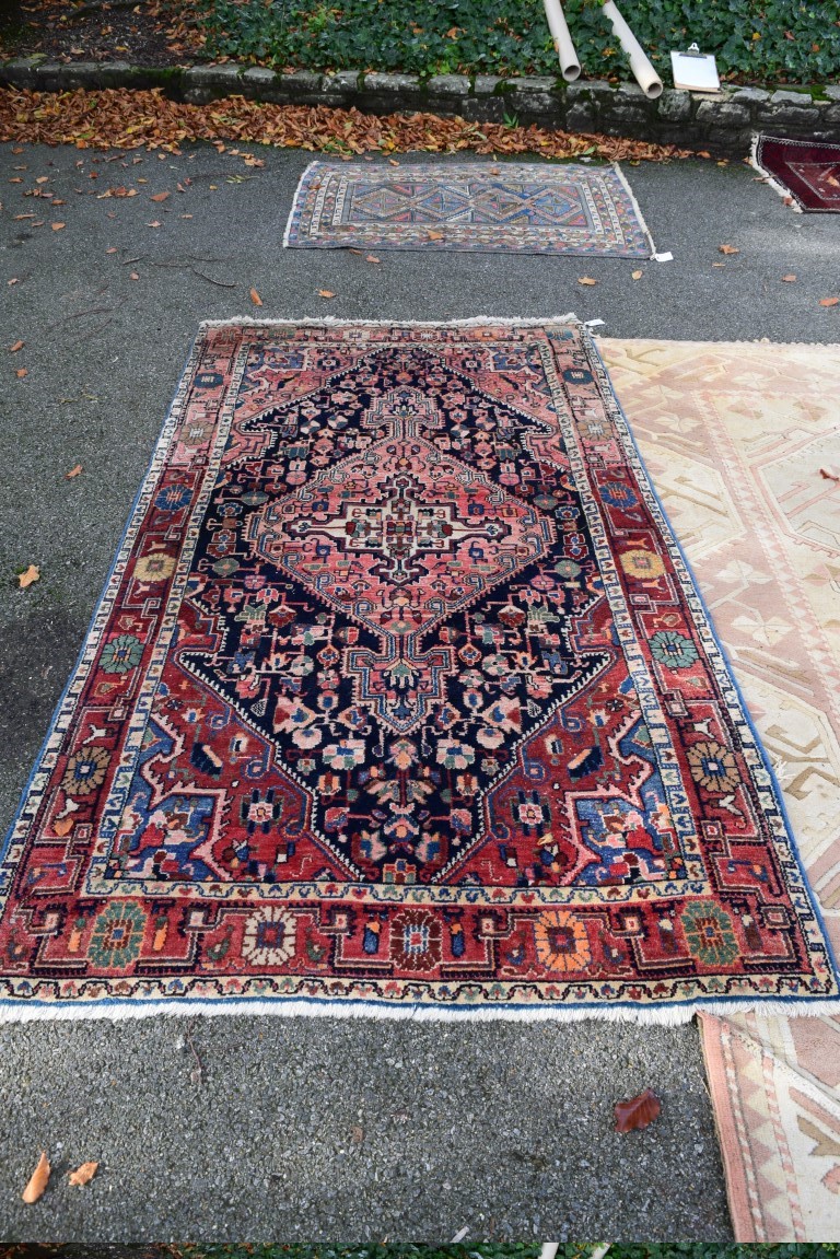 An Iranian rug, having red field with geometric design, 242 x 132cm.