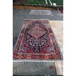 An Iranian rug, having red field with geometric design, 242 x 132cm.
