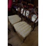 A pair of George III mahogany and inlaid dining chairs.